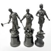 Three patinated spelter figures of blacksmiths, on plinths, tallest 31 cm.