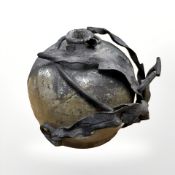 An unusual studio pottery globular vase with applied iron work vine decoration,