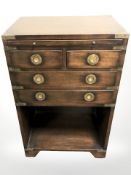 A mahogany campaign style brass mounted bedside stand, fitted drawers, width 46 cm.