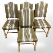 A set of four Danish blonde oak dining chairs in striped olive upholstery.