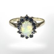 A 9ct yellow gold cluster ring set with synthetic opal and sapphire,