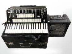 A Hohner Electravox Deluxe piano accordion, in carry case with instructions,