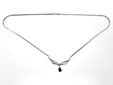 A 9ct yellow gold necklace set with a sapphire and diamond, length 44 cm.