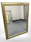 A contemporary bevelled gilt framed overmantel mirror, 91 cm x 117 cm.