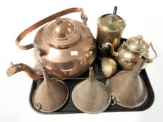 A large copper tea pot, three funnels, other brass items.