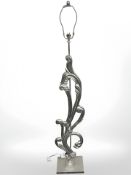 A contemporary decorative silvered standard lamp and a twin handled urn,