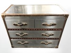 A leather and aluminium four drawer chest with canvas lined interior,