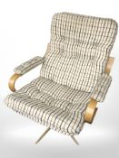 A Scandinavian bentwood swivel armchair in chequered fabric.