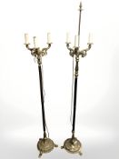 Two gilt brass tripod standard lamps.