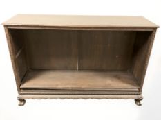 An Oriental heavily carved open bookcase,