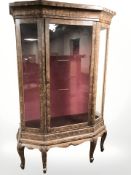 A continental glazed display cabinet in scumbled finish, 142 cm x 51 cm x 203 cm.