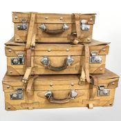 Three graduated tan leather luggage case,