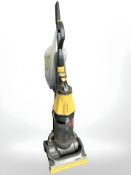 A Dyson upright vacuum cleaner.