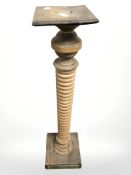 A 19th century pine torchere, height 116 cm.