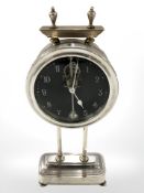 A chrome plated desk timepiece, with visible escapement, height 25.5 cm.