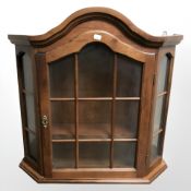 A reproduction glazed door wall cabinet,