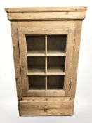 A 19th century pine glazed door cabinet,