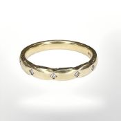 A 9ct yellow gold band ring set with diamonds, size M/N CONDITION REPORT: 2.7g.