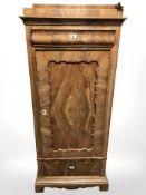 A 19th century continental walnut single door cabinet, 66 cm x 38 cm x 153 cm.
