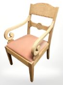 A Danish blonde oak armchair.
