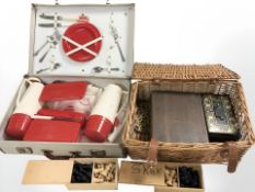 A picnic hamper and a luggage case containing Staunton chess sets, etc.