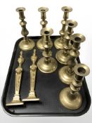 Seven various Victorian brass candlesticks and a pair of fireside ornaments.