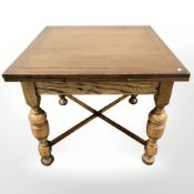 An early 20th century oak draw leaf extending dining table,
