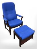 A Danish Farstrup stained wood armchair and matching footstool in blue fabric.