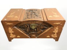 An Oriental heavily carved camphor wood blanket box,