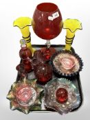 A group of cranberry glass items, three carnival glass dishes, oversized goblet,