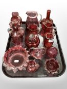 A collection of cranberry glass.