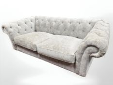 A contemporary Chesterfield style grey fabric settee, 110 cm x 200 cm x 75 cm.