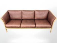 A Danish Skalma wood framed terracotta leather three seater settee, 203 cm x 84 cm x 80 cm.
