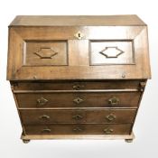 An early 19th century oak fall front bureau, 104 cm x 53 cm x 103 cm.