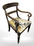 A Victorian mahogany armchair in modern upholstery.