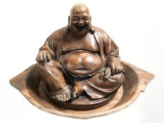 A twin handled rustic wooden dough bowl, width 57 cm, and a resin figure of a seated Buddha.