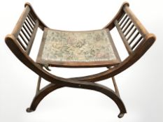 A Victorian beech X framed piano stool.