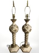 An ornate pair of contemporary cream and gilt lamp bases, height 78 cm.