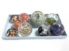 Nine glass paperweights including Caithness and Mdina.