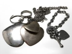 A costume pendant strung with three graduated hearts, a dress ring,