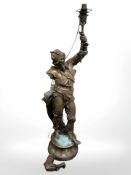 A patinated metal figural standard lamp in the form of a conquistador (as found), height 107 cm.