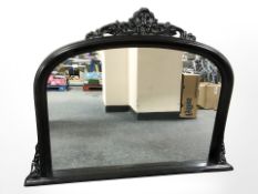 A reproduction ebonised over mantel mirror,