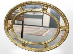 A contemporary oval panelled mirror, 72 cm x 92 cm.