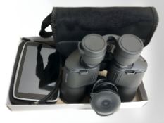 A pair of Eurohike 10 x 50 binoculars in pouch and a Tom Tom sat nav