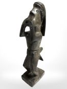 A painted wood ethnic carving of a blow dart hunter, height 38 cm.