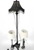 A contemporary patinated metal standard lamp and a pair of table lamps.