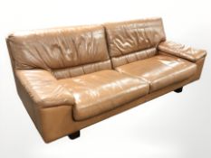 A late 20th century stitched tan leather three seater settee,