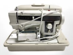 A New Home deluxe zig zag sewing machine with lead and pedal.
