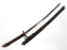 An ornate reproduction Japanese katana in sheath, with 69 cm blade.