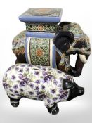 A ceramic elephant plant stand and a contemporary money box in the form of a pig.